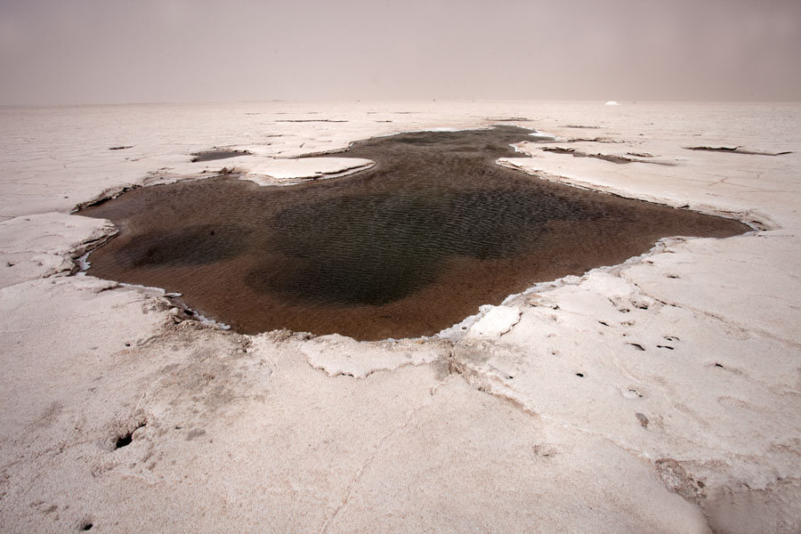 The eye of Salinas Grandes with brownish water with volcanic activity | Salinas Grandes | Argentina