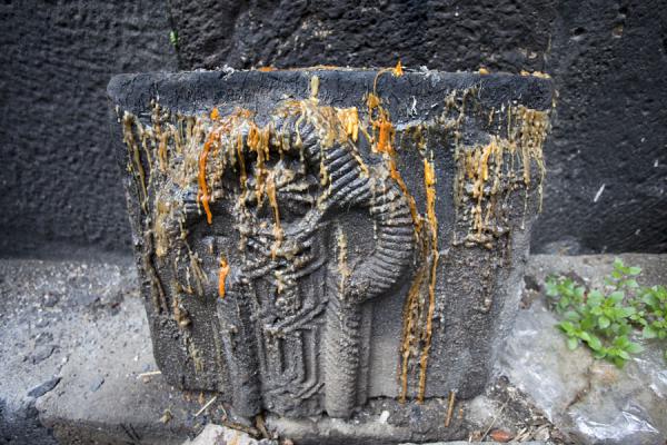 Picture of Kobayr Monastery (Armenia): Detail of a carved stone with melted candles in the church of Kobayr Monastery