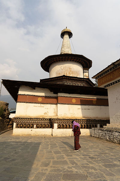 Picture of Dumtseg Lhakhang (Bhutan): One of the many worshippers walking around chorten-shaped Dumtseg Lhakhang