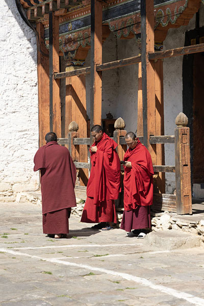 Picture of Monks on their phones inside Jakar Dzong - Bhutan