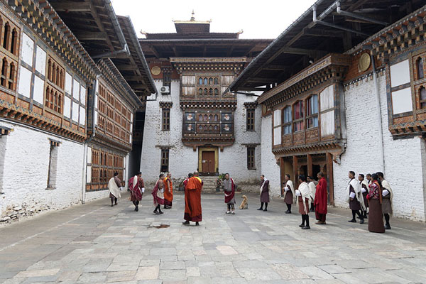 Foto van Monks and civilians in traditional clothes inside Lhuentse DzongLhuentse Dzong - Bhutan