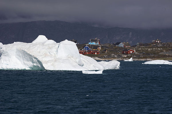 Colourful houses of Qoornoq visible behind an iceberg | Nuuk fjord | 