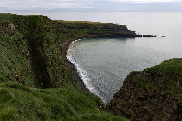 Steep cliffs and beach at the north side of Grímsey island | Grímsey Island | Iceland