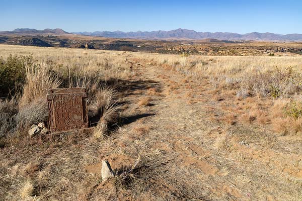 Tomb at the Royal Cemetery with grassy field covering the plateau of Thaba Bosiu | Thaba Bosiu | Lesoto