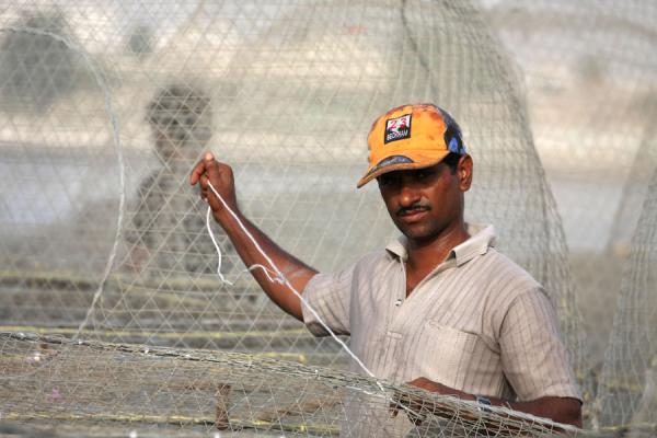 Photo de Fisherman in Al Khor getting his net togetherAl Khor - Qatar