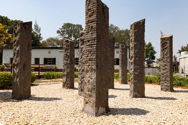 Ten stone columns representing the ten Belgian commanders who were killed on April 7, 1994 | Belgian Peacekeepers memorial | Ruanda